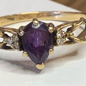 14kt gold deep purple stone and Diamond chips ring.missing one small diamond